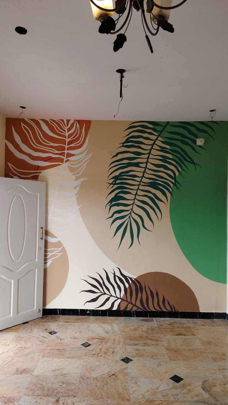Abstract tropical leaf mural in orange, green and cream