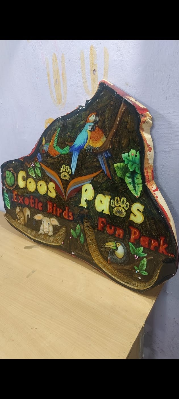 Custom shaped wood signage board painted with birds and animals, finished with epoxy resin, for a fun park